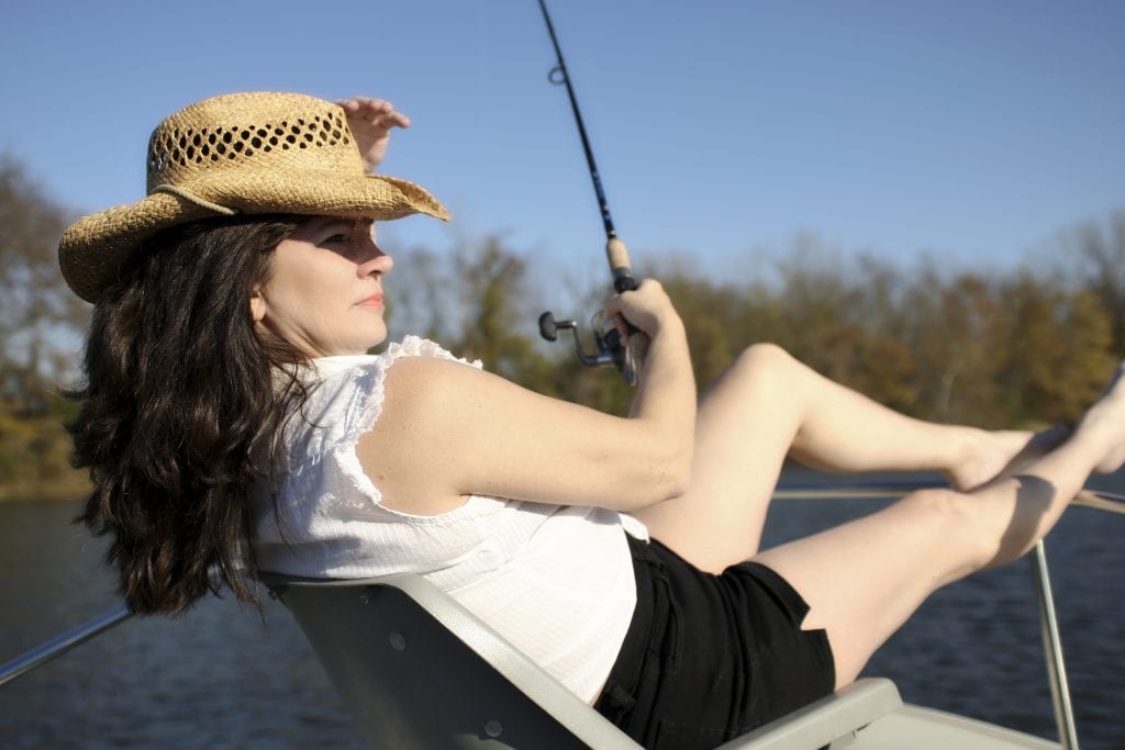 bigstock Mature Woman Fishing on a Boat 40625977