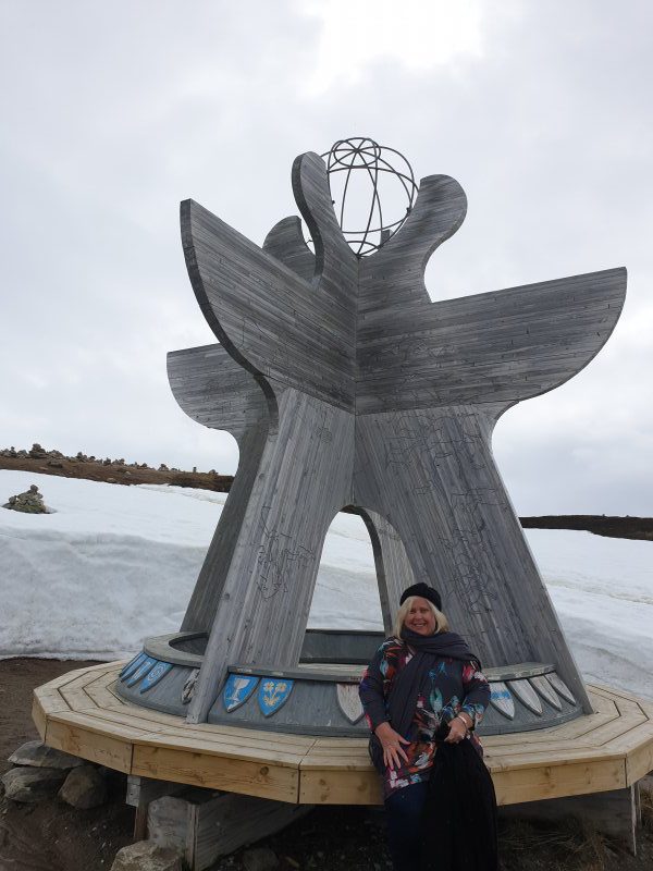 Nicole Anderson at one of the arctic circle markers Norway