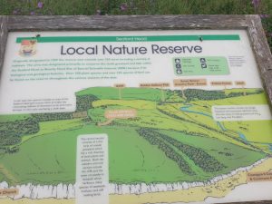 Seaford Local Nature Reserve area of South Downs National Park sign showing nearby attractions